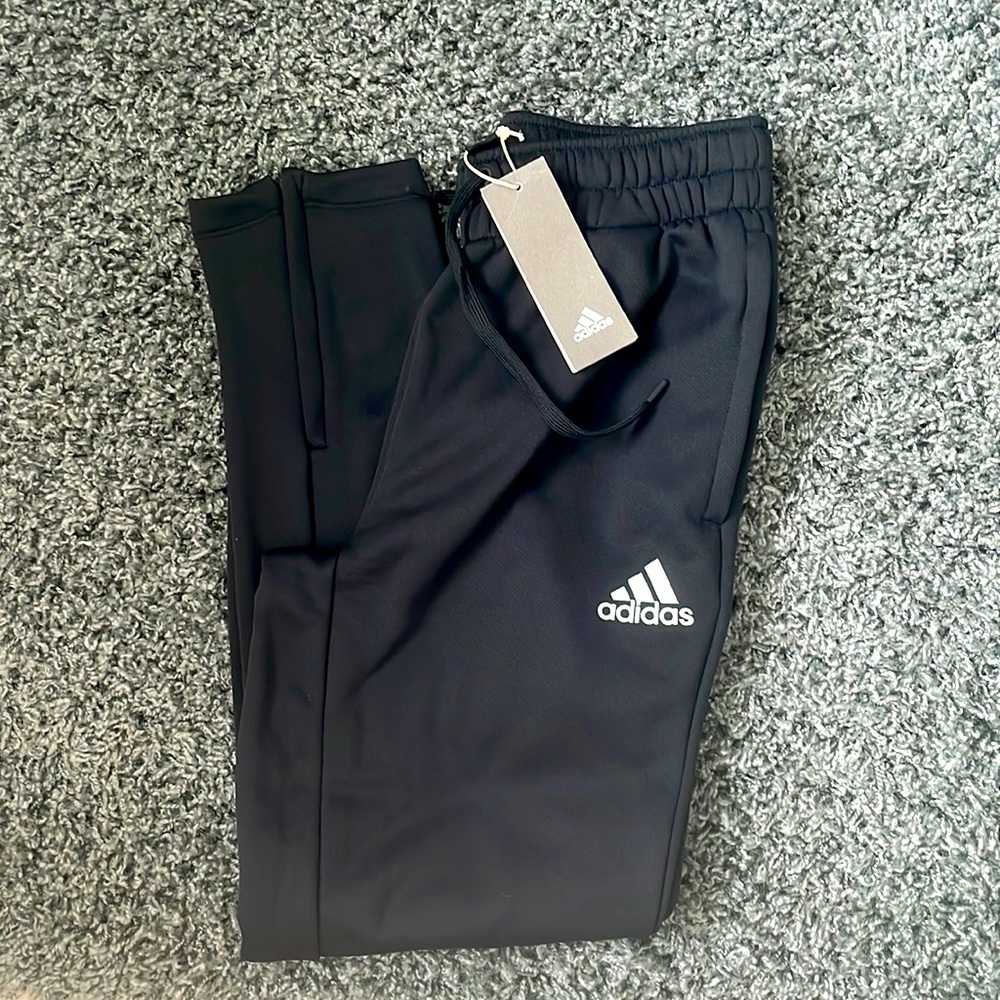 Men's black Adidas sweatpants. Size small with pockets and bottom leg zipper.
